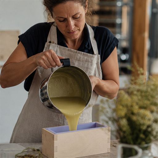 Maker pouring soap into a mold